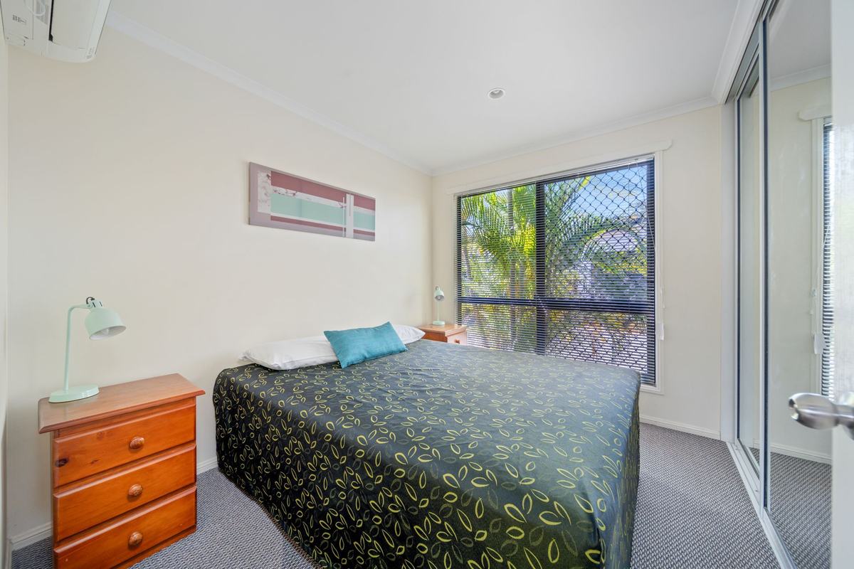 Executive Queen apartment bedroom with a garden-view window
