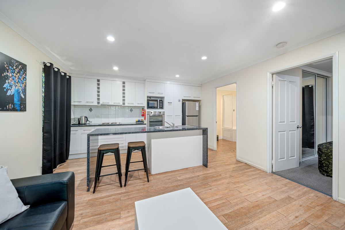 Kitchen and living area in the Executive Queen Family apartment
